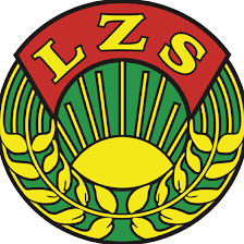 Zielono-żółte kłosy zboża wokół żółtego półkola, na czerwonym półkolu żółte litery LZS.